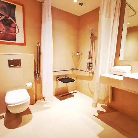 Holiday Inn Bengaluru Racecourse By Ihg Exterior photo A disabled toilet with a shower seat